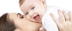 mom kissing baby